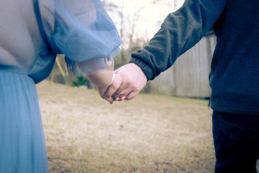Hands intertwined in golden light