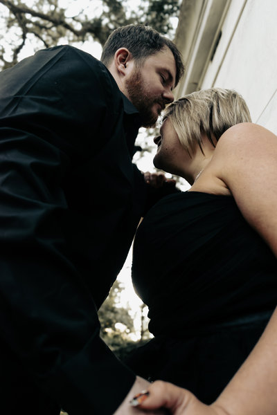 Couple slow dancing under a warm hanging lamp
